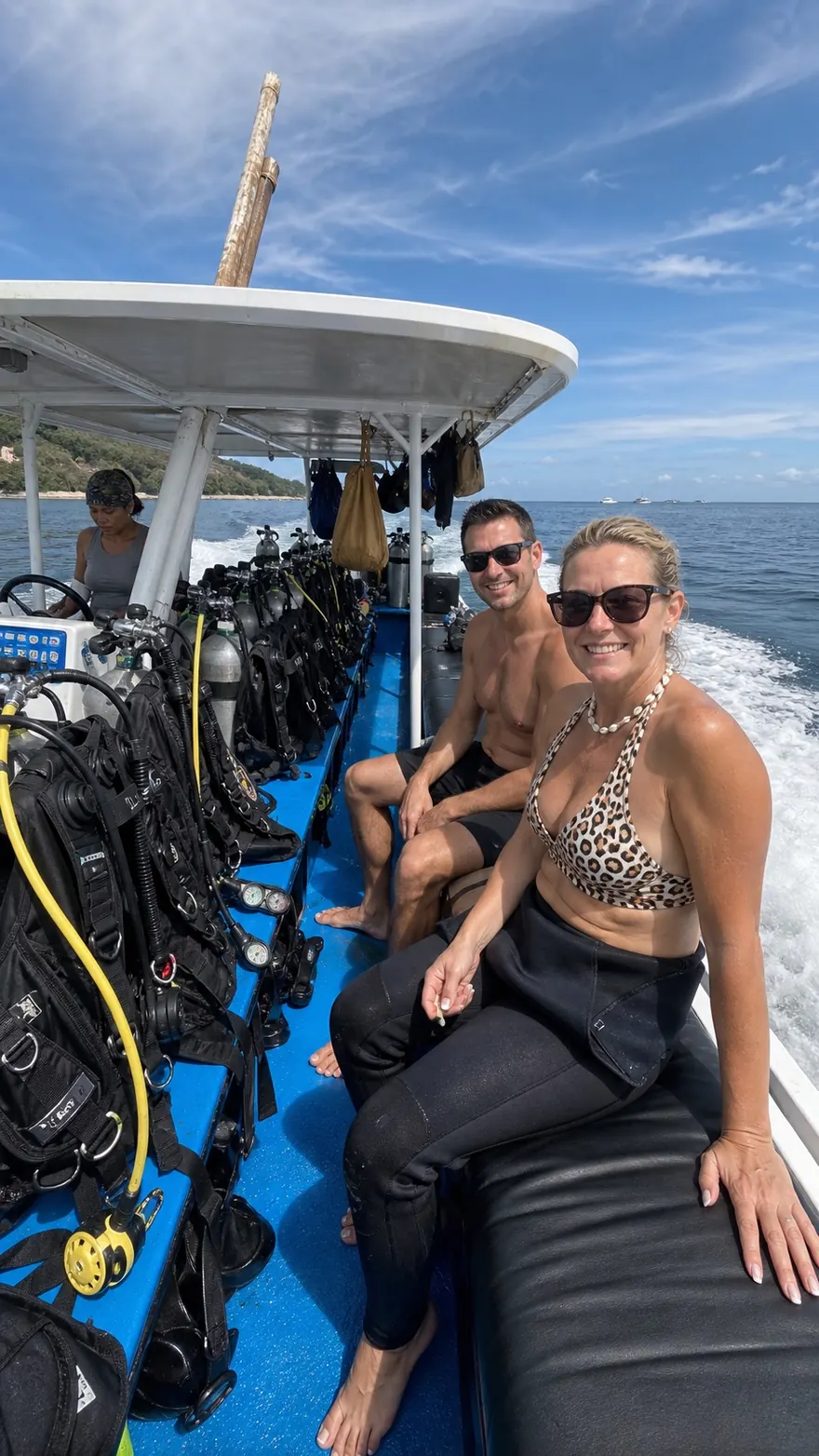 Dive Boat Bench: Smiling on the bench of an open dive boat at sea