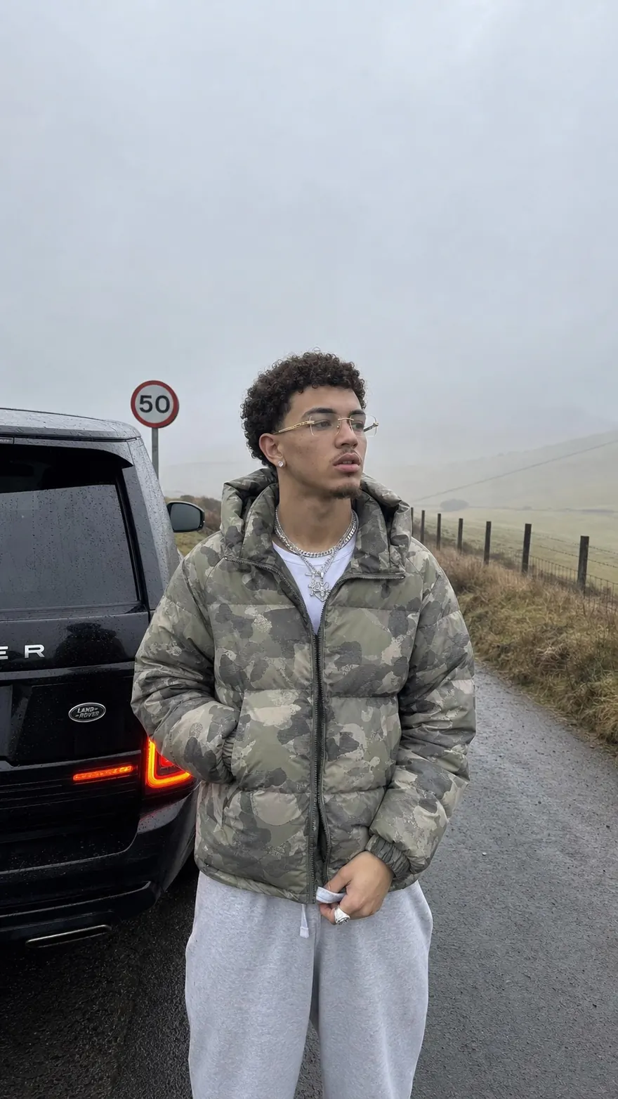 Foggy Roadside Portrait: Camo puffer and a Range Rover on a misty country road
