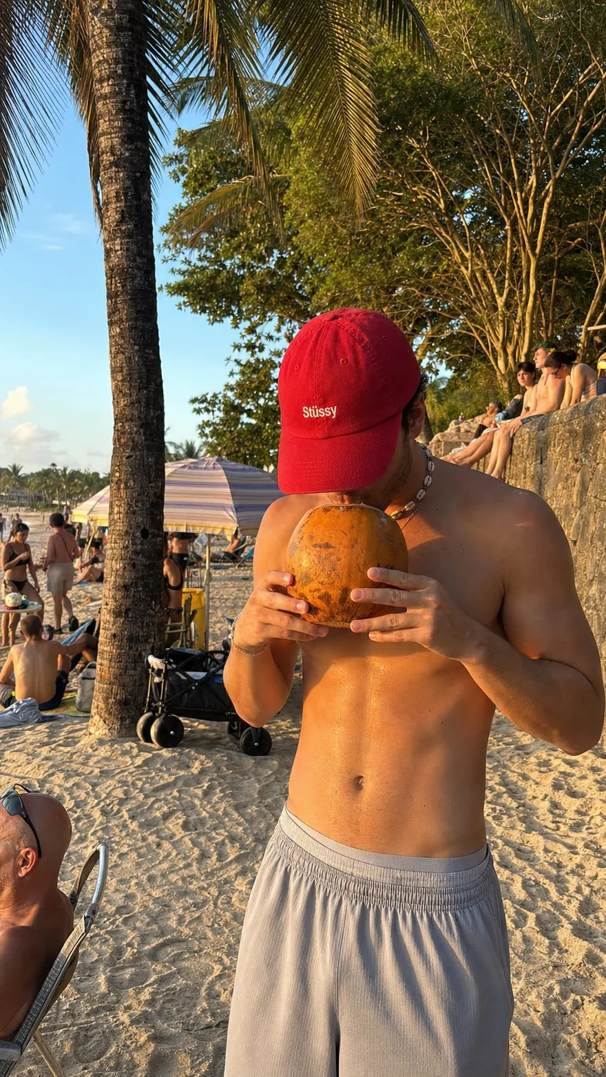Golden Hour Coconut: Red cap and puka shells, coconut at golden hour