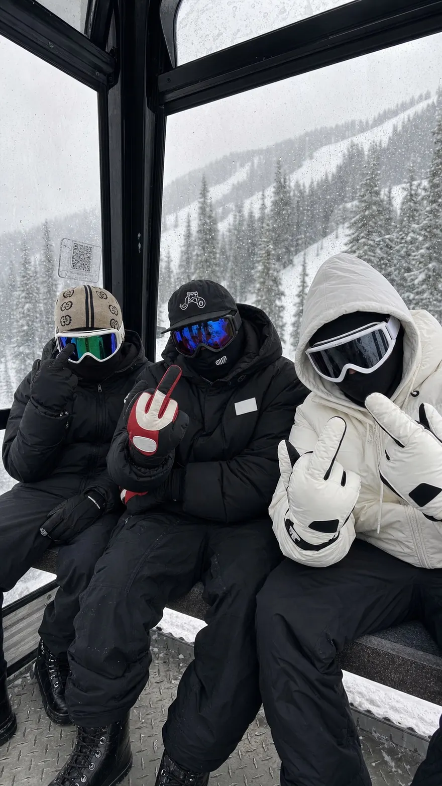 Gondola Crew: Three friends in full ski kit riding up in the gondola