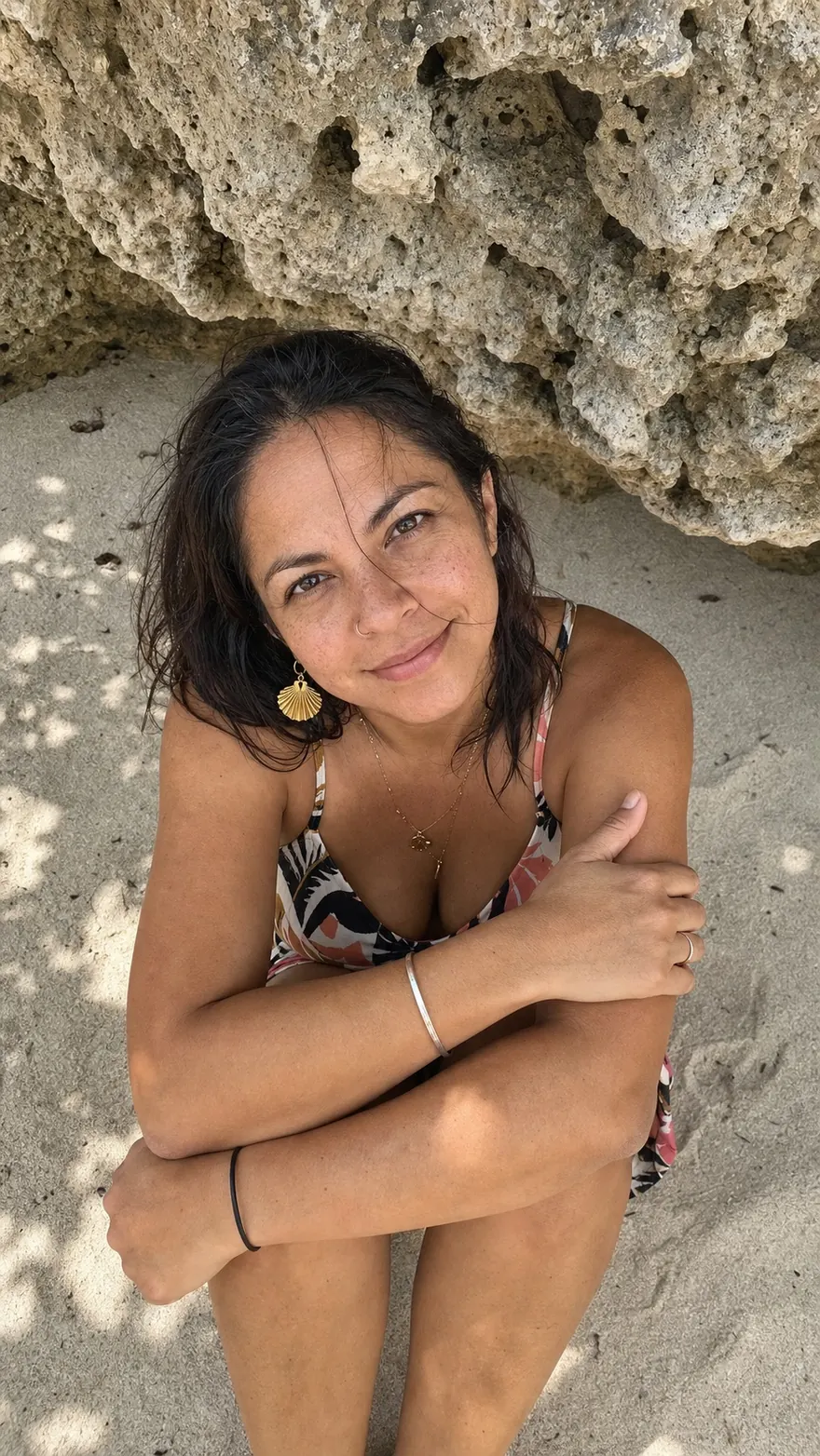 Limestone Overhang: Sitting on pale sand under an eroded rock overhang