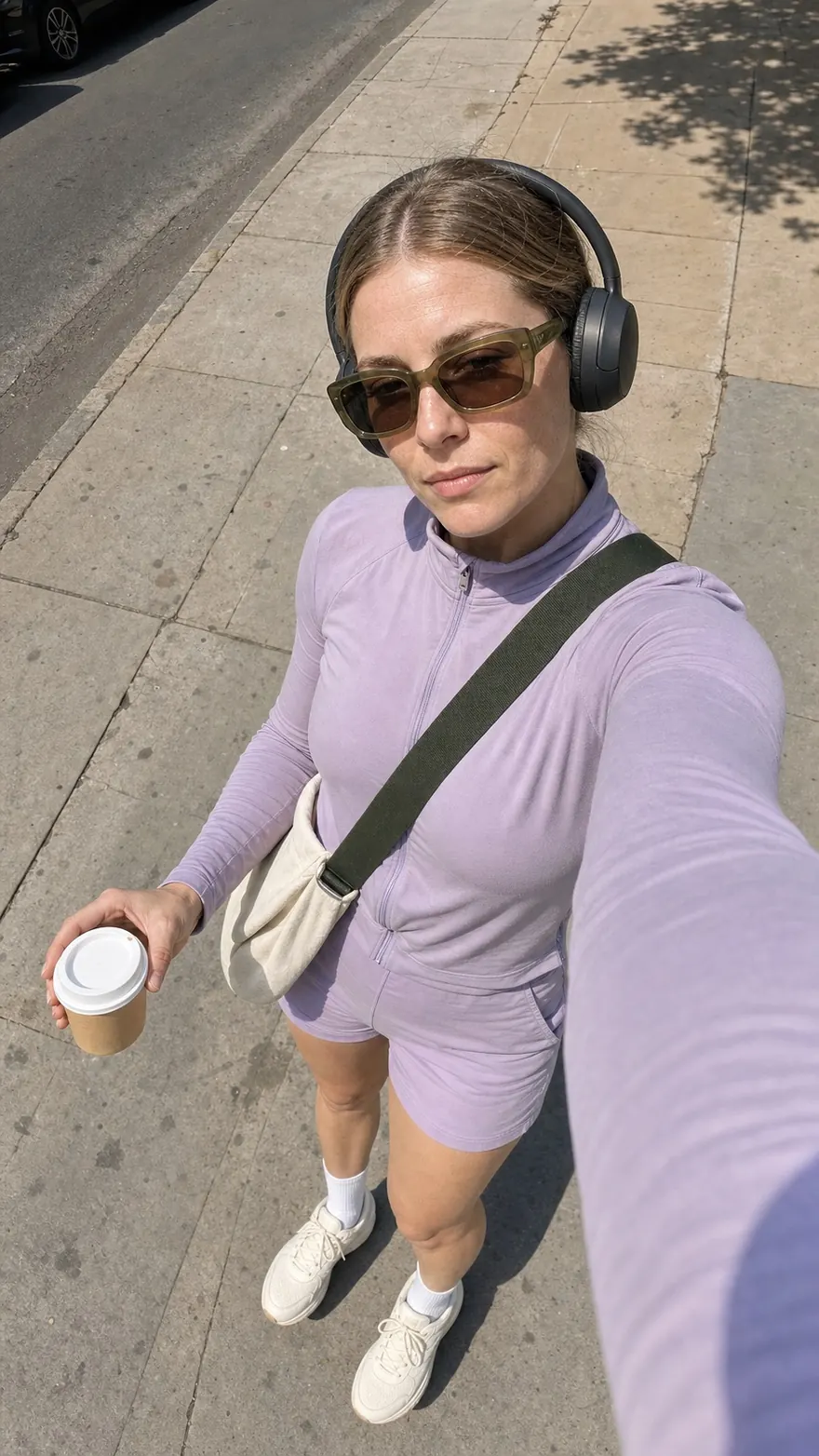 Sidewalk Headphones Selfie: Overhead walking selfie in oversized headphones