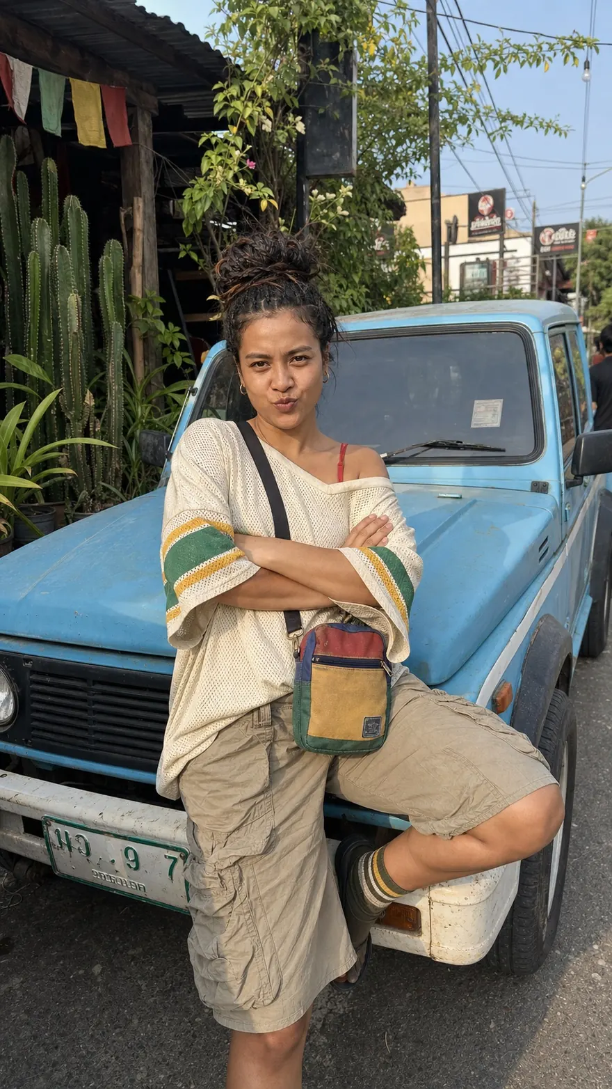 Sky-Blue Off-Roader: Leaning on a weathered blue 4x4 in the street