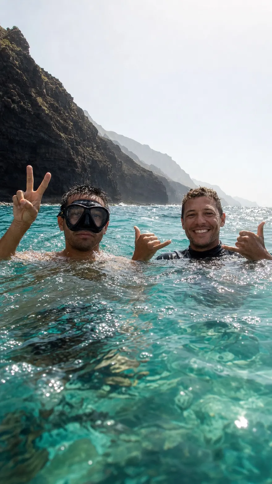 Water-Level Float: Two divers treading turquoise water, camera at the surface